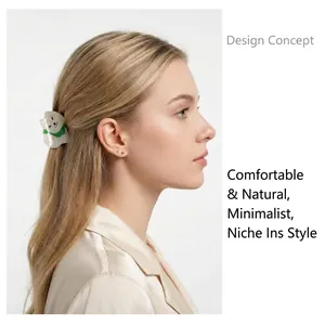 Close-up of a cute white animal hair claw clip worn by a model in a profile view