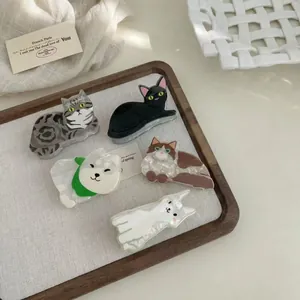 Five cute animal cat and dog hair claw clips displayed on a minimalist wooden tray