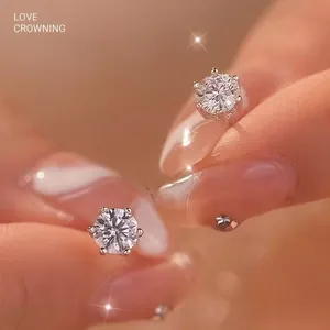 Elegant macro view of brilliant round-cut Moissanite silver stud earrings with four-prong setting