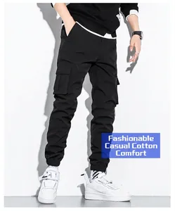 Detail of men's black cotton cargo pants with multiple side pockets and jogger cuffs