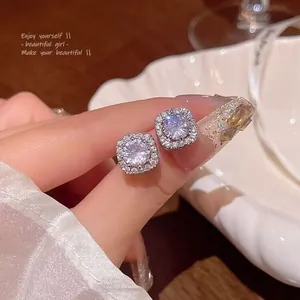 Close-up of S925 sterling silver square halo stud earrings with sparkling moissanite