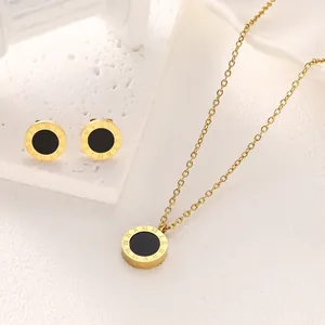 Minimalist gold titanium steel jewelry set featuring Roman numeral round pendants