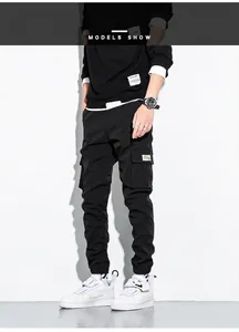 Detailed view of men's black cargo jogger pants with multi-pocket design