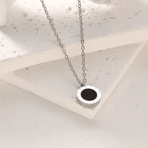 Close-up of titanium steel necklace with Roman numeral engraved circular pendant