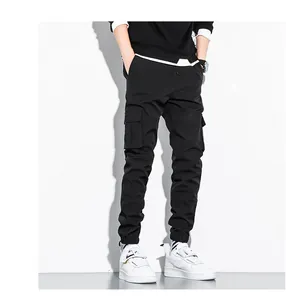 Detailed close-up of black men's cotton cargo pants with multiple pockets and elastic cuffs