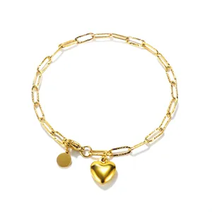 Minimalist gold stainless steel chain necklace with heart pendant and round tag.