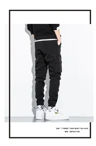 Detailed back view of men's black cotton cargo pants featuring stylish multi-pocket design