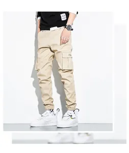 Detail shot of men's khaki cargo joggers with side flap pockets and cuffed ankles
