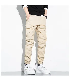 Detailed view of khaki cotton cargo pants with multi-pockets and cuffed ankles