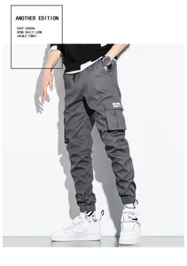 Detailed view of men's grey cotton cargo pants with multi-pockets and cuffed jogger ankles