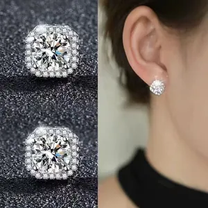 Detailed close-up and ear model view of square halo moissanite stud earrings in silver