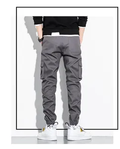 Back view of grey cotton cargo pants for men featuring multiple functional pockets