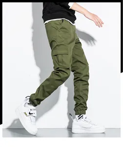 Side profile detail of army green cargo pants for men featuring a large utility pocket
