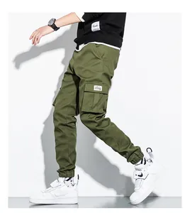 Detailed view of olive green cotton cargo jogger pants with multiple side pockets