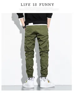 Detail view of men's olive green multi-pocket cotton cargo jogger pants from the back
