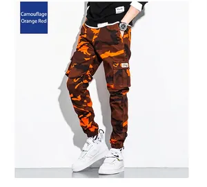 Detailed close-up showing the orange and brown camouflage pattern of men's cargo joggers