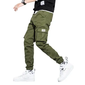 Stylish men's olive green cotton cargo pants with multiple pockets and cuffed hems