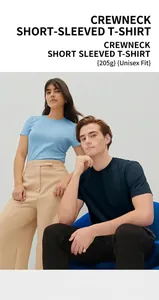 Detail view of 205g cotton crewneck t-shirts worn by a male and female model in studio