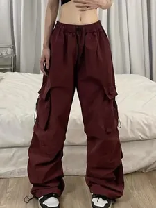 Detailed view of dark red high-waisted nylon quick-dry parachute cargo pants