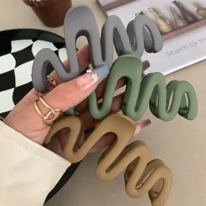 Set of three matte wavy hair claw clips in grey green and khaki