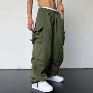 Detailed view of olive green quick-dry nylon cargo parachute pants with elastic waist