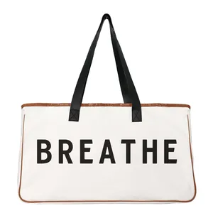 Large minimalist white canvas tote bag with black handles and BREATHE print design