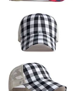 Close-up of black and white gingham trucker hat with ponytail hole and mesh back.