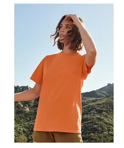 Orange ring-spun cotton oversized T-shirt worn outdoors against mountain landscape