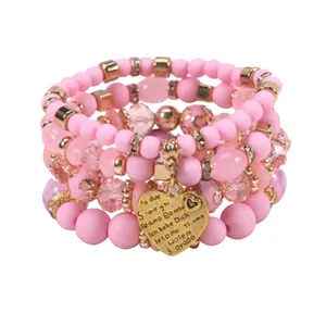 Bohemian style pink beaded stack bracelet with multi-language engraved heart charm