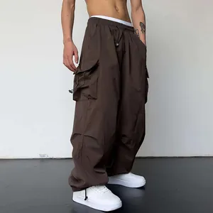 Men's dark brown oversized nylon parachute cargo pants with wide leg and drawstrings