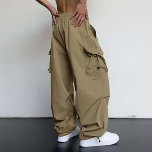 Detailed back view of tan nylon quick-dry cargo parachute pants with side pockets.