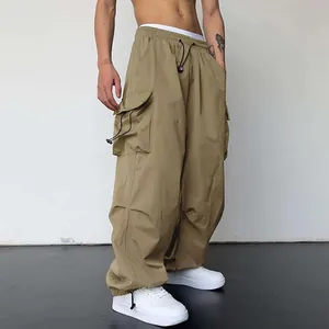 Detailed close-up of khaki nylon cargo parachute pants featuring a high waist and wide leg fit