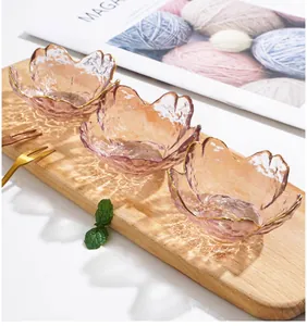 Close-up of elegant pink Japanese cherry blossom shaped glass sauce dishes with gold rim