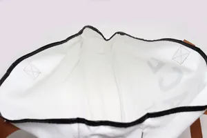 Close-up view showing the spacious interior and black piping of the white canvas beach tote bag