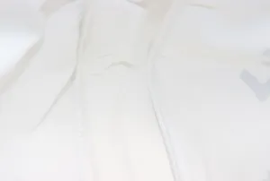 Close-up detail of high-quality white cotton-linen canvas fabric showing neat stitching