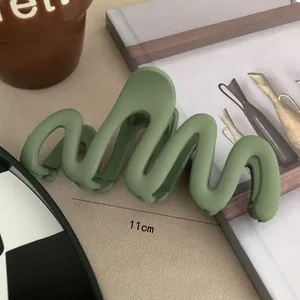 Detailed macro view of a 11cm avocado green matte wavy hair claw clip accessory