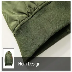 Primer plano detallado del dobladillo elástico acanalado de una clásica chaqueta bomber MA1 verde.