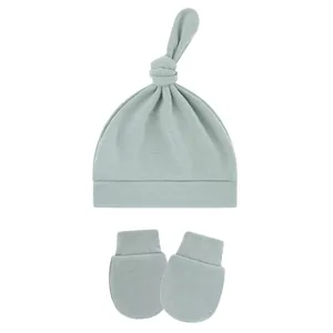 Detail view of light blue baby knotted hat and matching anti-scratch mittens set