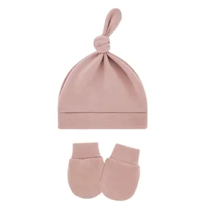 Soft pink breathable baby knit hat with top knot and matching anti-scratch mittens set