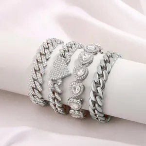Elegant four-piece silver Cuban link bracelet set featuring heart charms and rhinestones