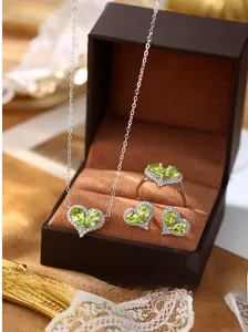 Detailed view of heart-shaped peridot jewelry set in a luxury box