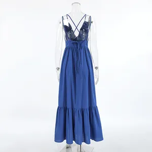 Back view of blue cotton linen spaghetti strap maxi dress with ruffled hem detail