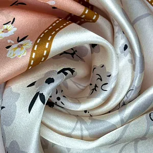 Macro detail of mulberry silk scarf showing soft texture and elegant floral pattern.