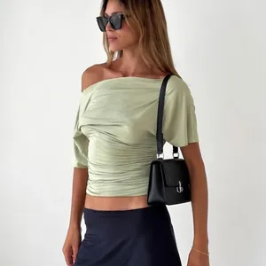 Close-up detail of a sage green off-the-shoulder slim fit T-shirt featuring elegant ruched design