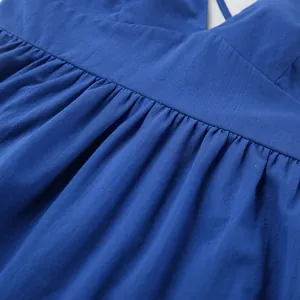 Detail shot showing the pleated texture of a blue cotton linen V-neck maxi dress
