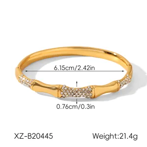 Detail view of a gold bamboo-shaped rhinestone bangle showing 6.15cm inner diameter.
