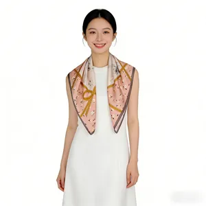 Elegant mulberry silk 65cm square scarf with pink floral and gold bow pattern on model