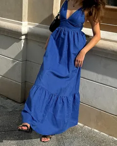 Detailed view of a blue V-neck cotton linen maxi dress featuring a tiered ruffle hemline.