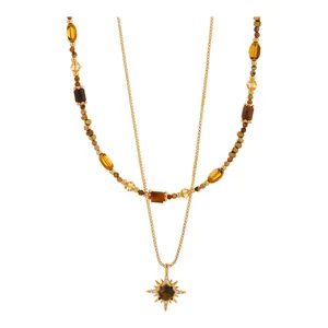 Layered gold necklace featuring tiger's eye stone and elegant sunburst sunflower pendant