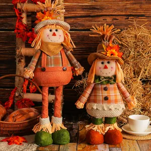 Harvest Thanksgiving scarecrow dolls with maple leaf straw hats and plaid outfits